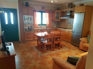 a kitchen with a wooden table and a dining room at Casa Flor in Punta Mujeres