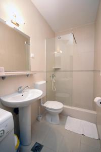 a bathroom with a sink and a toilet and a shower at Apartmani More in Sveti Stefan +33 photos