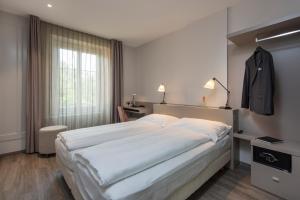 Postel nebo postele na pokoji v ubytování Hôtel du Théâtre, Boutique Hôtel