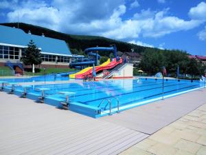 a large swimming pool with a water slide at Apartament Bieszczadzkie Klimaty in Ustrzyki Dolne