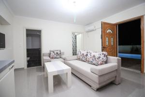 a living room with a couch and a table at Villa Aleandro in Ksamil