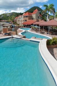 a large swimming pool with blue water in a resort at Divi Little Bay Beach Resort in Philipsburg