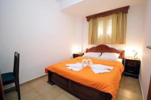 a bedroom with a bed with two towels on it at Apartmani More in Sveti Stefan