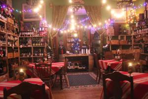 a restaurant with tables and chairs and christmas lights at Riverview Mansion Hotel in Golconda
