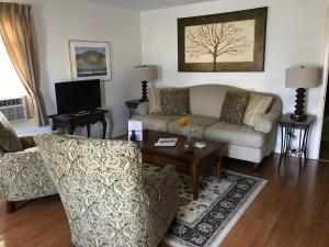 a living room with a couch and a table at Channel Bass Inn and Restaurant in Chincoteague