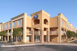 an exterior view of a hotel with a parking lot at Days Inn by Wyndham Greenville in Greenville