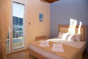a bedroom with a bed with two towels on it at Arion Hotel in Skala Potamias
