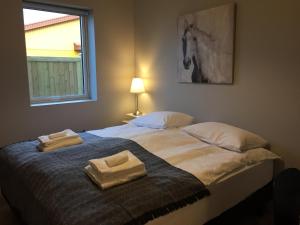 A bed or beds in a room at Reykjadalur Guesthouse