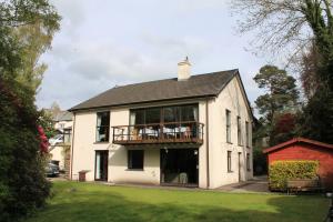 a large white house with a balcony on top of it at Meadfoot Guesthouse Room only accommodation for Adults in Windermere