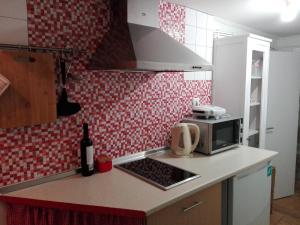 a kitchen with a counter top with a microwave at Era Uma Vez Apartment in Vila Real