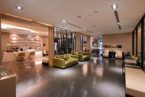 a lobby with couches and chairs in a building at Kiwi Express Hotel - Kaohsiung Station in Kaohsiung