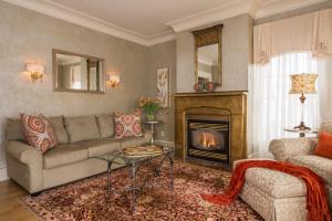 a living room with a couch and a fireplace at Captain Farris House in South Yarmouth
