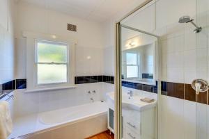 a white bathroom with a tub and a sink at Tarraleah Estate in Tarraleah +50 photos