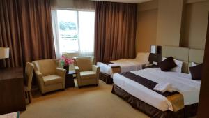 Ένα ή περισσότερα κρεβάτια σε δωμάτιο στο Lintas View Hotel