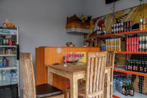 a table with two chairs and a book on it at Nyoman Guesthouse Canggu in Canggu