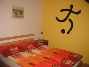 a bedroom with a bed with a sign on the wall at BED & BREAKFAST penzion Brno in Brno