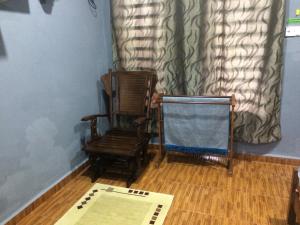 a room with two rocking chairs and a table at Roomstay Zulmi in Arau