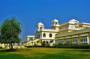 a large building with a tree in front of it at Sanchal Fort in Bārmer