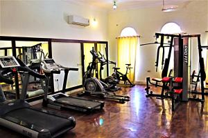 a gym with several treadmills and exercise bikes at Sanchal Fort in Bārmer