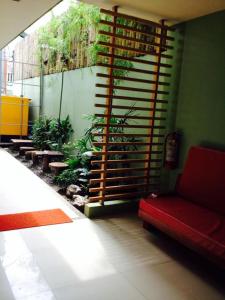 a living room with a red couch and plants at Shore Time Hotel - Annex in Boracay
