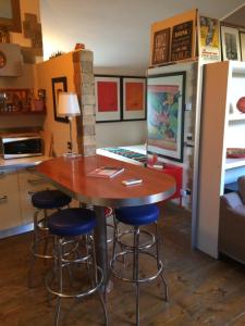 a kitchen with a wooden table and stools at The Resident Ancona in Ancona