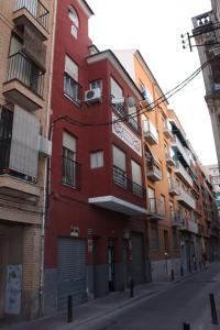 a red building on the side of a street at Arrabal de San Benito II in Murcia