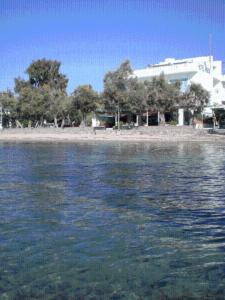 a large body of water with a building in the background at Hotel Paros in Parikia