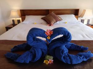a large blue towel is laying on a bed at Radya Homestay in Nusa Lembongan