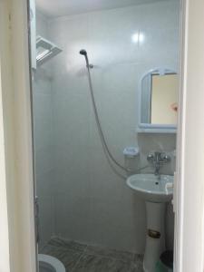 a bathroom with a shower and a sink at Ureki GuestHouse in Ureki