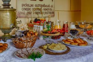 a table topped with plates of food at Hotel Kupechesky in Krasnoyarsk