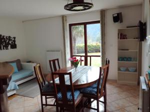 a dining room with a table and chairs and a couch at Pri Mlinarju in Tolmin