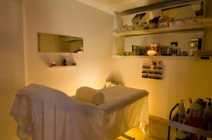 a exam room with a white chair in a room at El Cortijo de Zahara by QHotels in Zahara de los Atunes