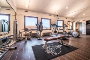 a gym with treadmills ellipticals and exercise equipment at Hotel Palace Bonvecchiati in Venice