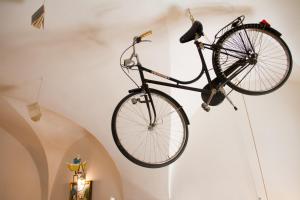 a bike hanging on a wall in a room at La piccola casa di Tania in Terlizzi +15 photos
