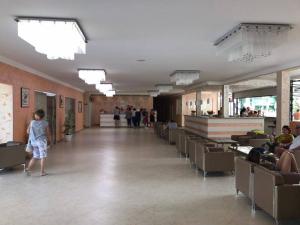 a large room with chairs and people in a building at Hotel Riva Park - All Inclusive in Sunny Beach +75 photos