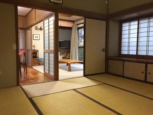 a room with a door open to a living room at Daikokuya Mt.Fuji in Fujiyoshida