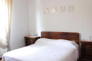 a bedroom with a white bed and two night stands at Marilide in Marotta