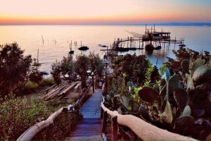 a pathway leading to a dock with a boat in the water at Prince Apartment in Vasto