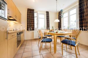 a kitchen and dining room with a table and chairs at Villa Hildegard by Callsen in Binz