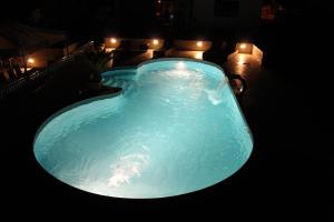 a large blue swimming pool at night with lights at Villa Kimberly in Rovinj