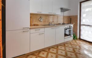 a kitchen with white cabinets and a sink at Apartmaji in Vinogradništvo Klobas in Sečovlje