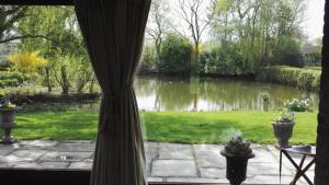 a view of a pond from a window at les Bovrieres in Cysoing