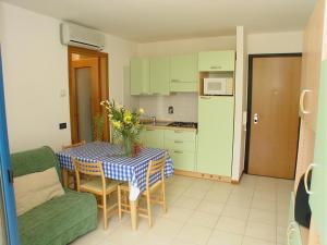 a kitchen with a table with a blue and white table cloth at Residence Terme in Grado