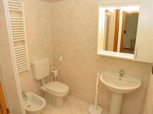 a bathroom with a toilet and a sink and a mirror at Residence Terme in Grado