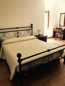 a bedroom with a large bed with a white blanket at B&B La Dimora del Capitano in Fabriano