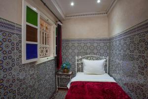 Säng eller sängar i ett rum på Hotel Zaitoune