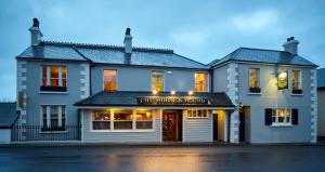 a building with a sign on the front of it at Horse & Hound in Delgany