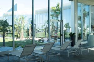 a row of chairs in a building with windows at Mjus Resort & Thermal Park in Körmend