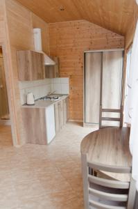 a kitchen with a table and a counter top at Domek Letniskowy Pucka in Mieroszyno +8 photos