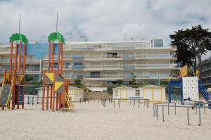 a playground on the beach in front of a building at Appartement La Baule Plage in La Baule